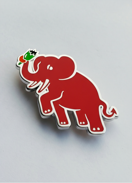 Red elephant automotive grille badge with silver accents on a gray background